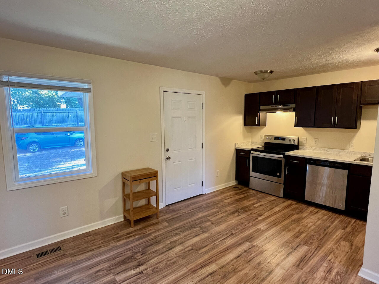 1421 Creech Road Garner, NC 27529 - Photo 7 of 22 a kitchen with a stove and a refrigerator