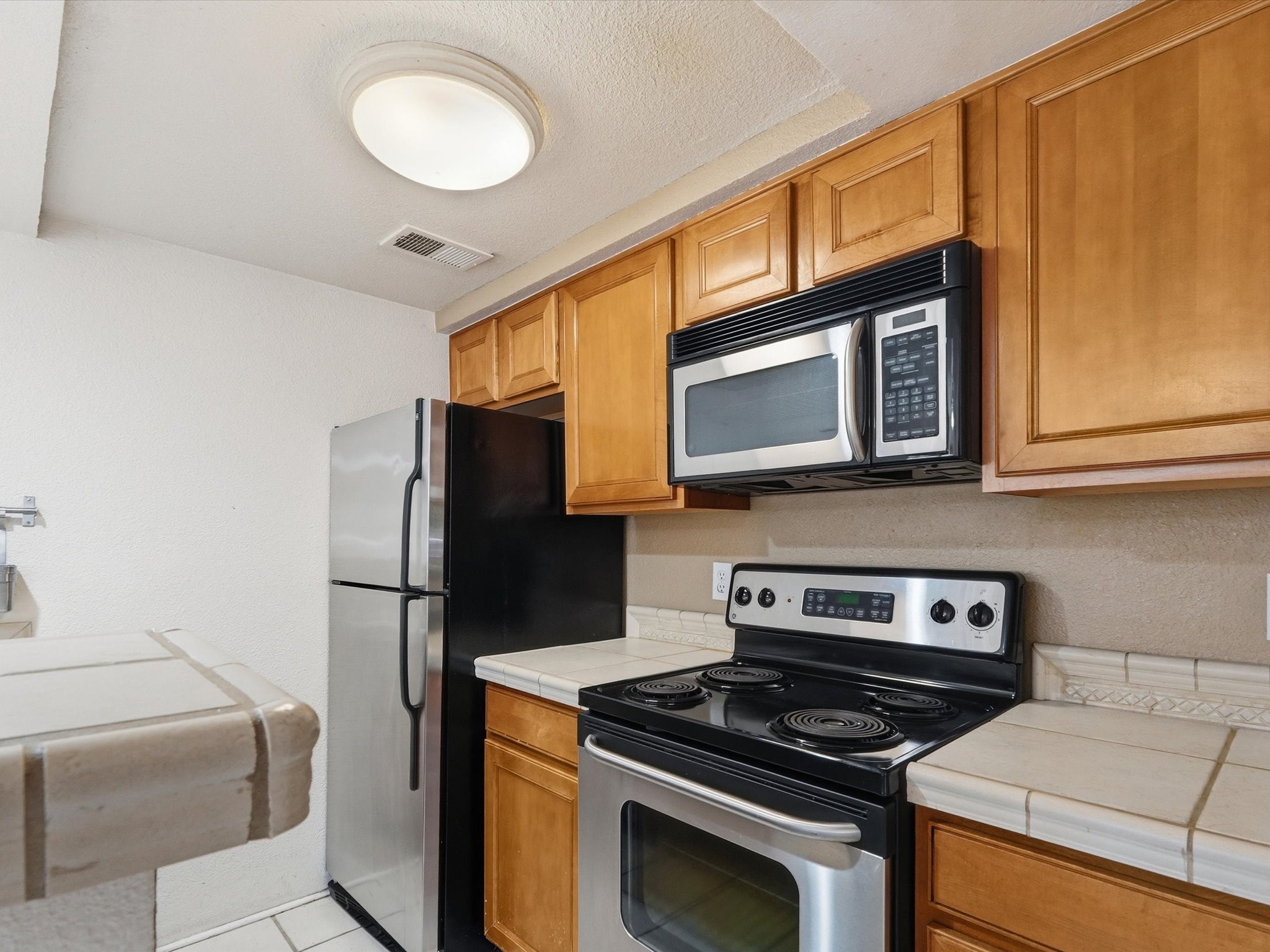 2210 Miguel Chavez Road, Unit 411 Santa Fe, NM 87505 - Photo 9 of 59 Kitchen area is equipped with kitchen appliances for daily use of the new owner