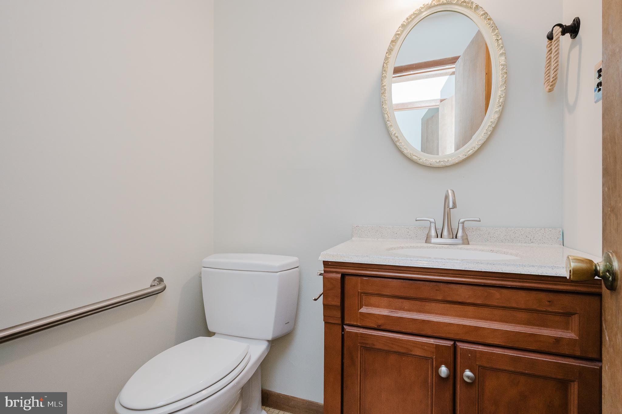 2713 Garrett Road White Hall, MD 21161 - Photo 11 of 60 a bathroom with a toilet a sink and a mirror