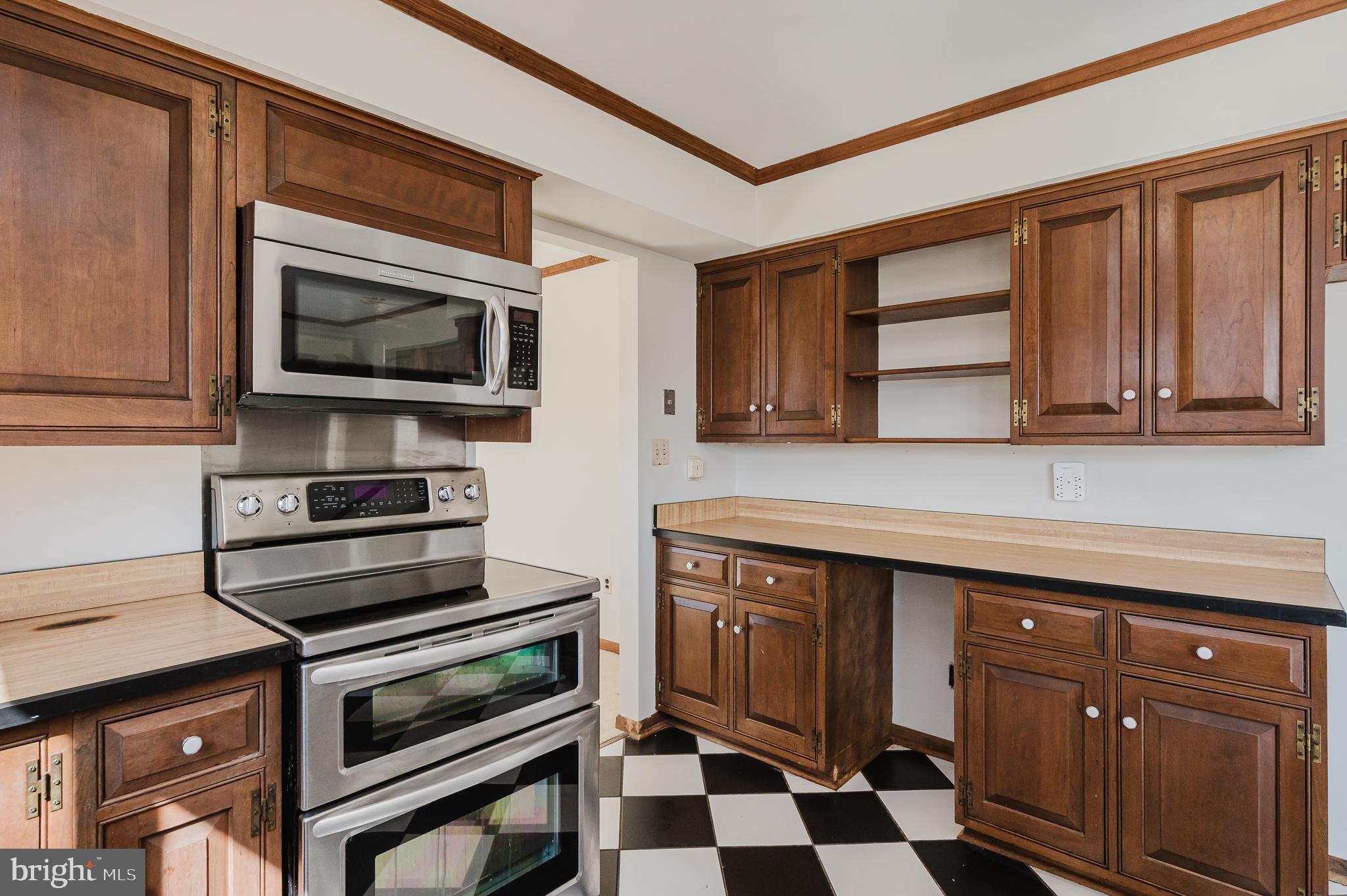 2713 Garrett Road White Hall, MD 21161 - Photo 15 of 60 a kitchen with a stove microwave and cabinets