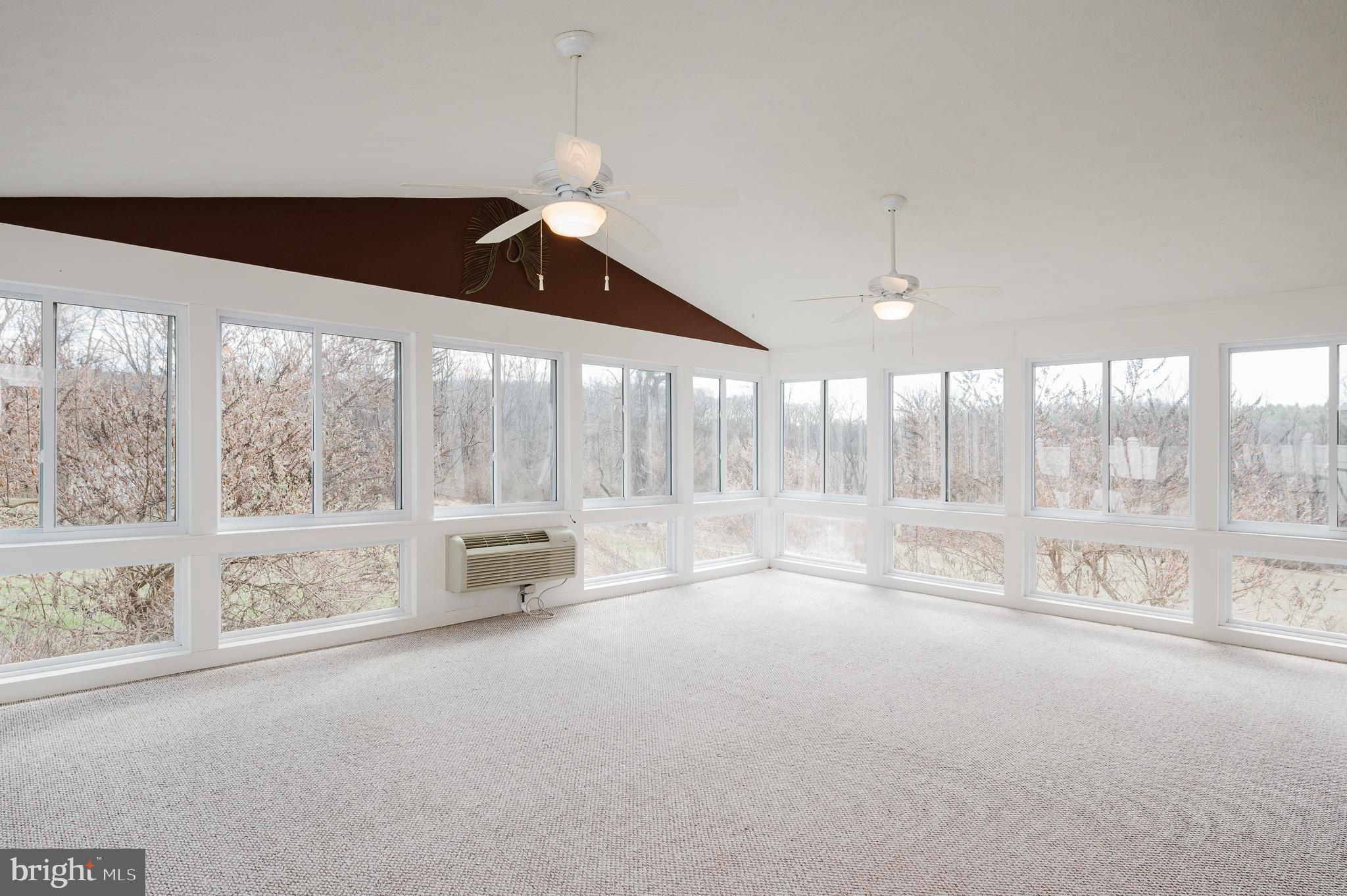 2713 Garrett Road White Hall, MD 21161 - Photo 28 of 60 an empty room with floor to ceiling window and an outdoor view