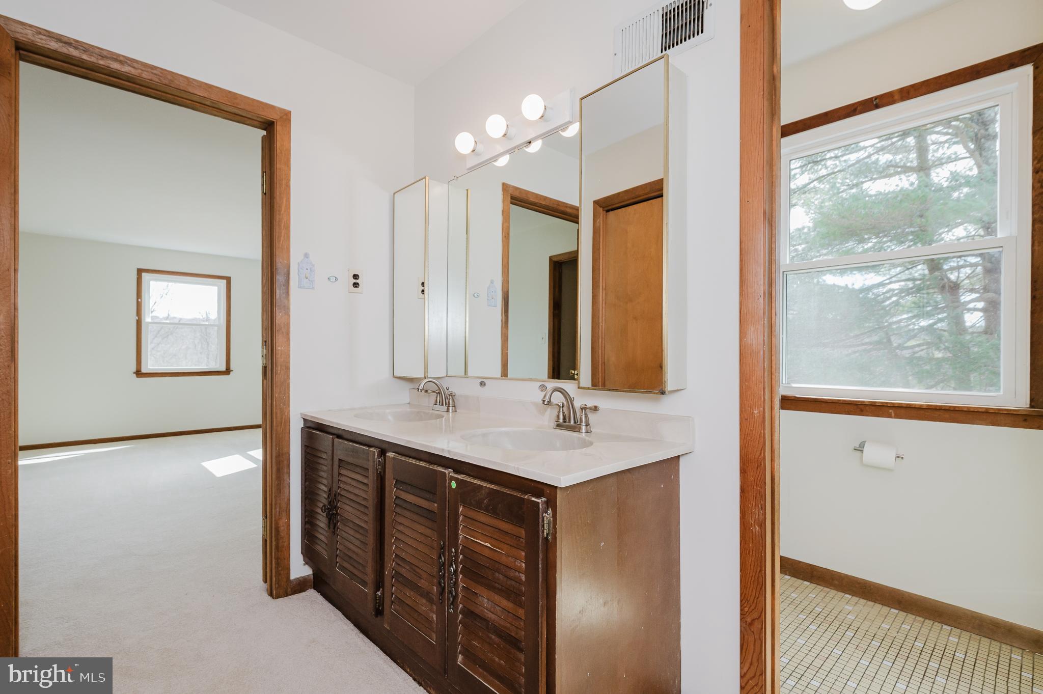2713 Garrett Road White Hall, MD 21161 - Photo 33 of 60 a bathroom with a double vanity sink and a mirror