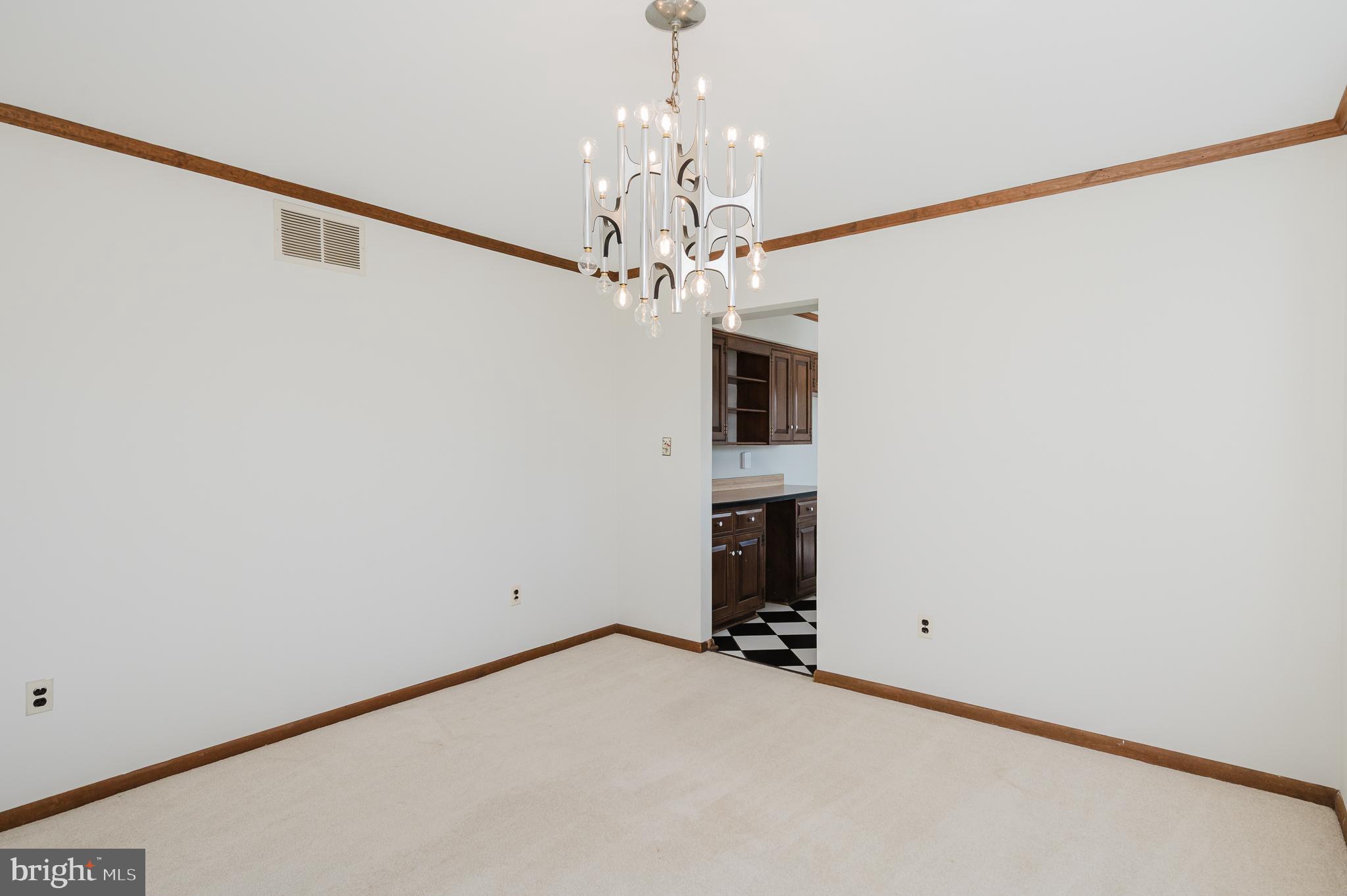 2713 Garrett Road White Hall, MD 21161 - Photo 9 of 60 a view of a room with a chandelier and a ceiling fan