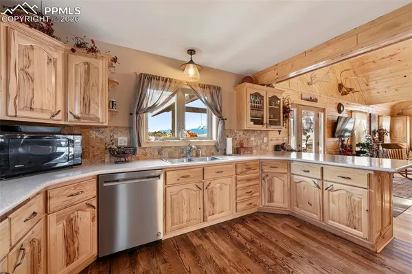 a large kitchen with granite countertop lots of counter top space and dining table