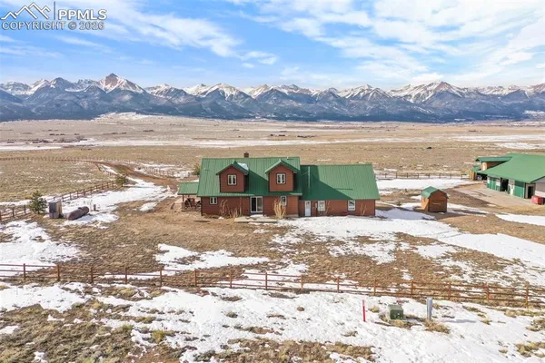 a front view of a house with a yard and road