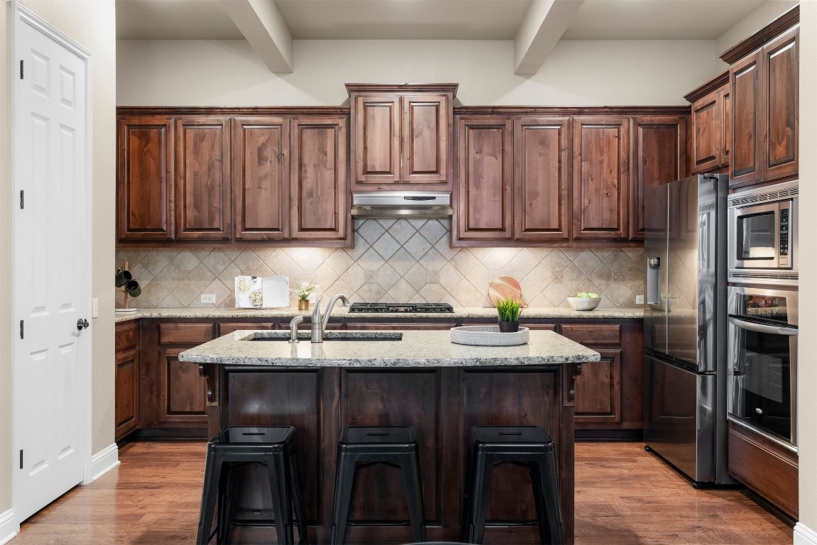 2020 Antone Street Austin, TX 78723 - Photo 19 of 35 a kitchen with kitchen island granite countertop wooden cabinets and a granite counter tops