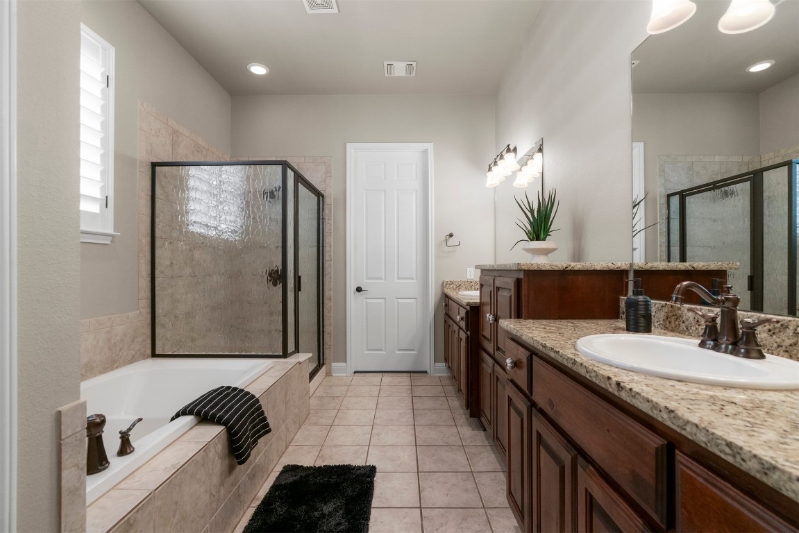 2020 Antone Street Austin, TX 78723 - Photo 23 of 35 a bathroom with a double vanity sink a mirror and a shower