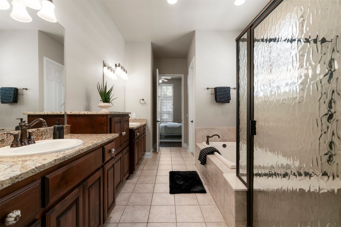 2020 Antone Street Austin, TX 78723 - Photo 24 of 35 a en suite bathroom with a sink and a mirror