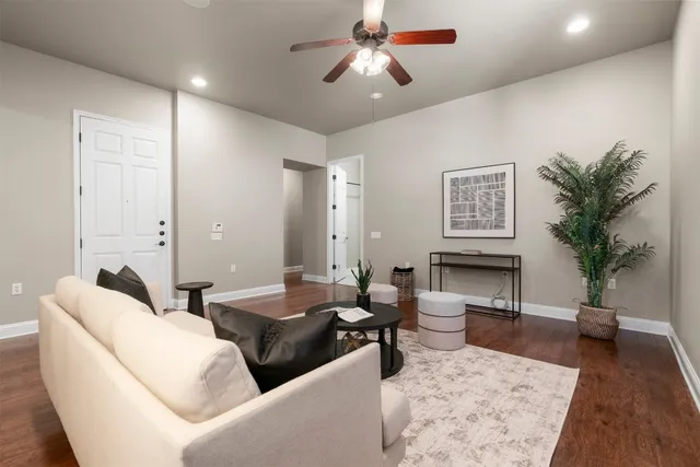a living room with furniture and a potted plant