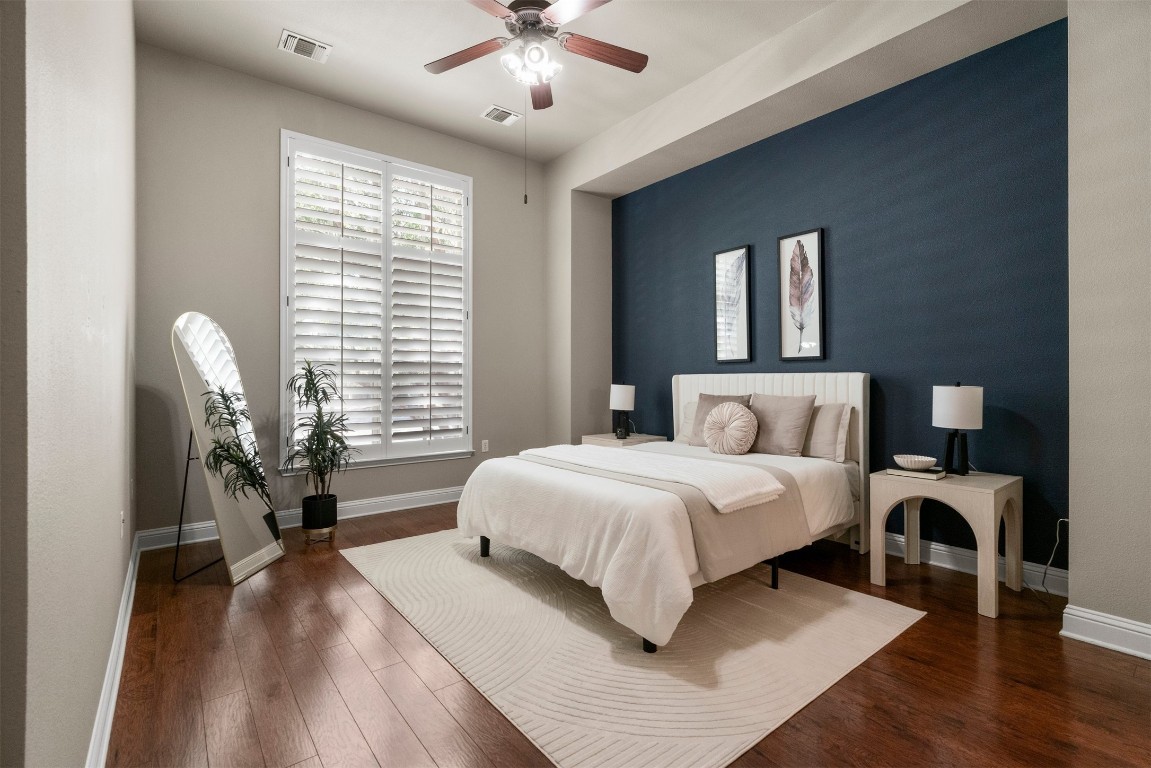 2020 Antone Street Austin, TX 78723 - Photo 5 of 35 a spacious bedroom with a bed a dresser and wooden floor