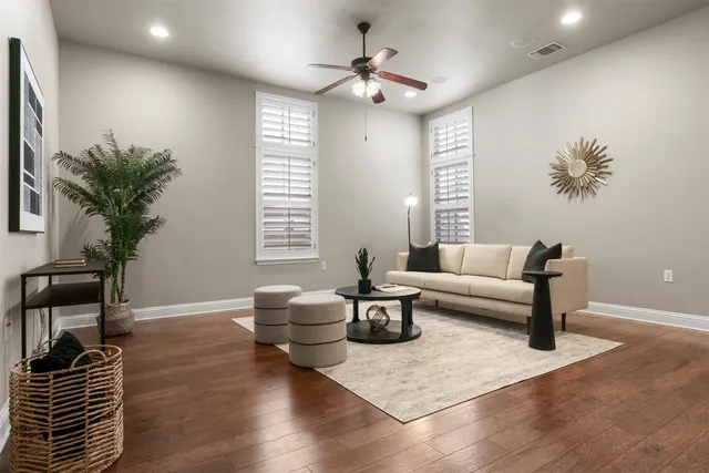 a living room with furniture and a potted plant
