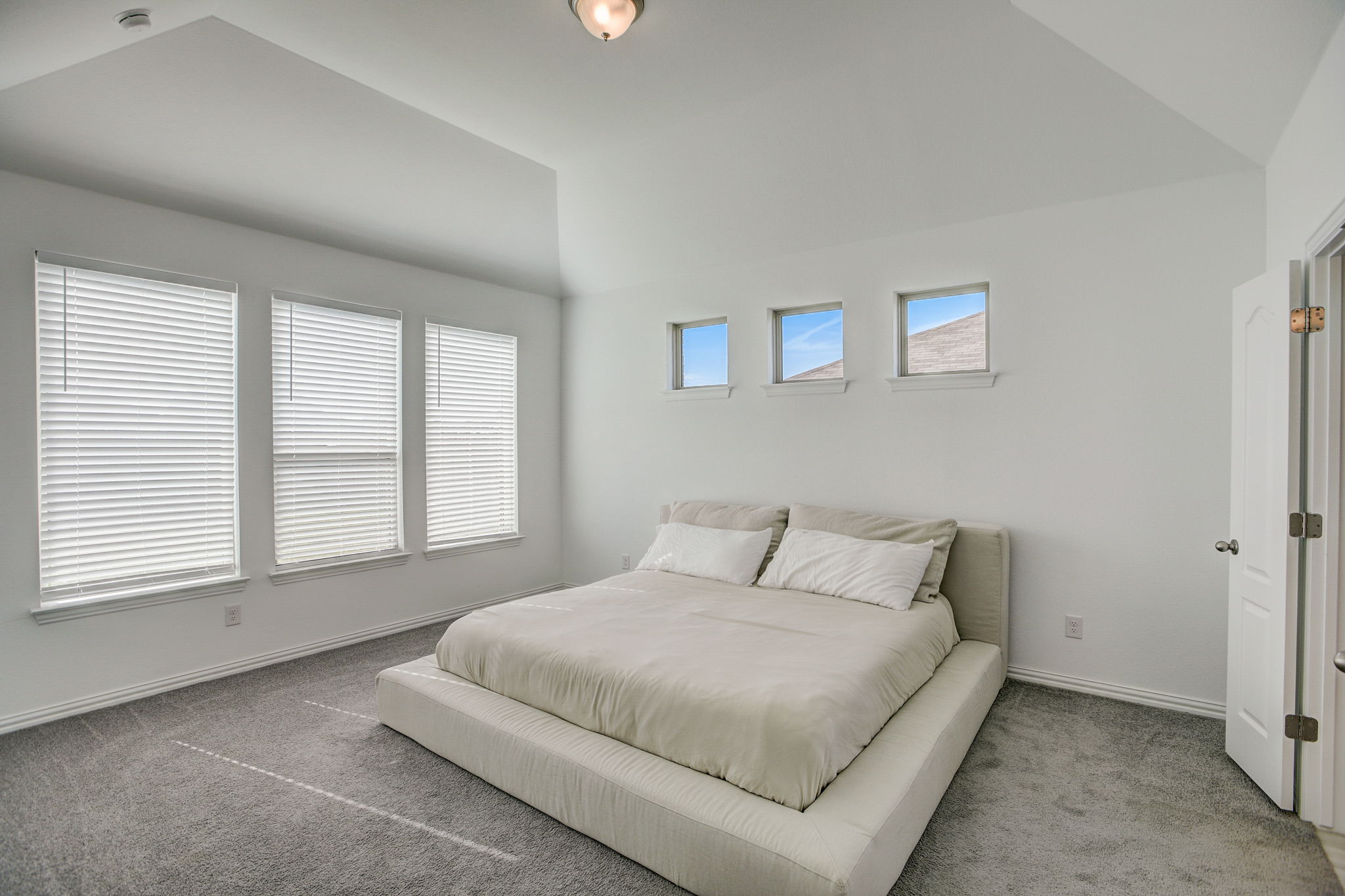 308 Monteforte Road Hutto, TX 78634 - Photo 13 of 32 a bedroom with a bed and a large window