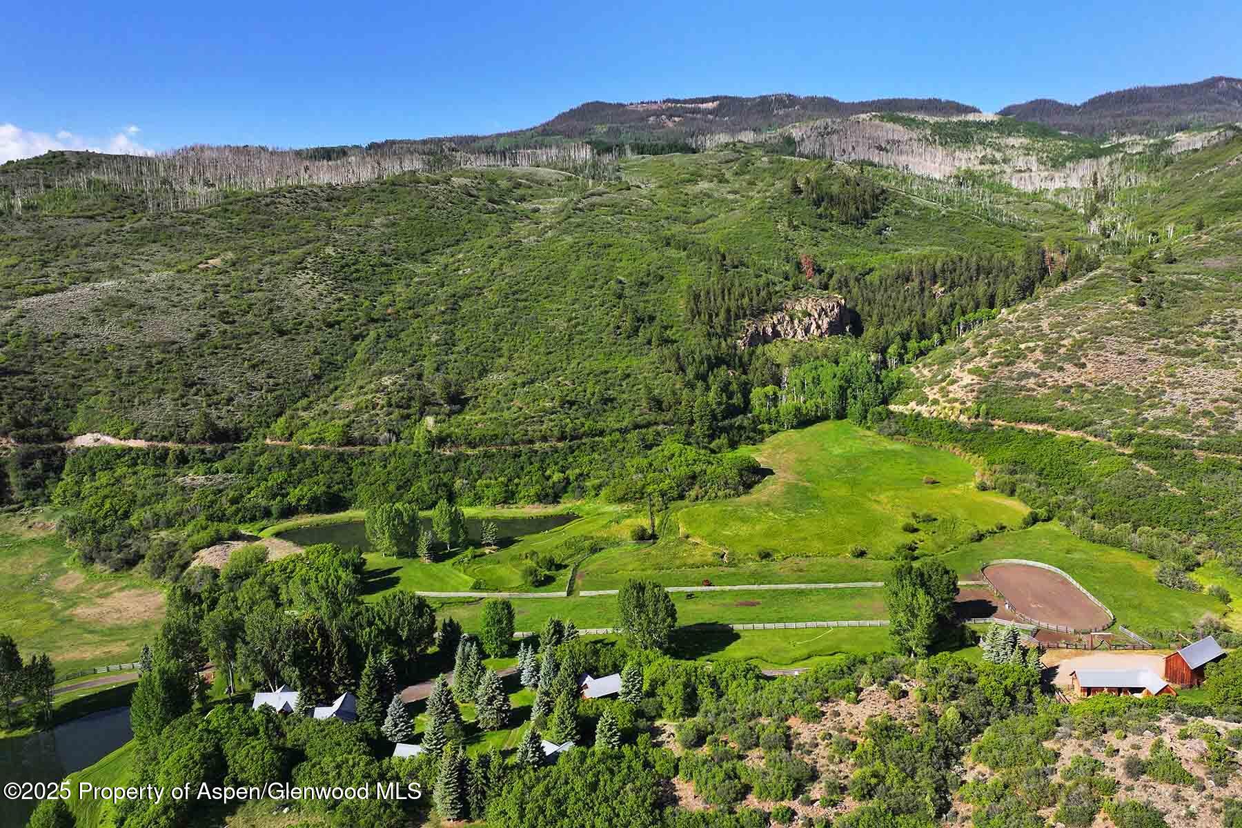 2650 Sweetwater Road Gypsum, CO 81637 - Photo 30 of 87 a view of a lush green forest with mountains in the background