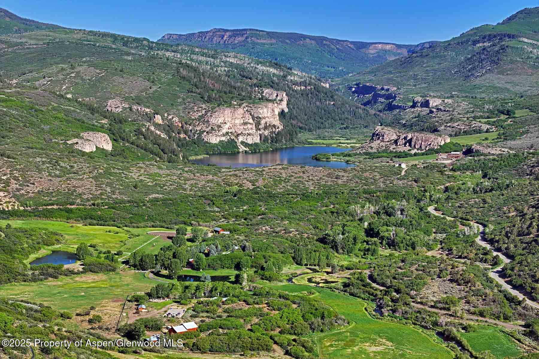 2650 Sweetwater Road Gypsum, CO 81637 - Photo 33 of 87 a view of a lush green hillside and a houses