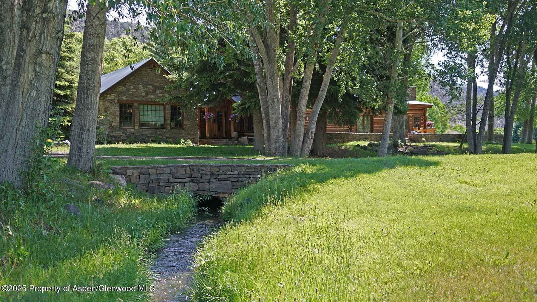 2650 Sweetwater Road Gypsum, CO 81637 - Photo 48 of 87 a view of a house with backyard and a tree