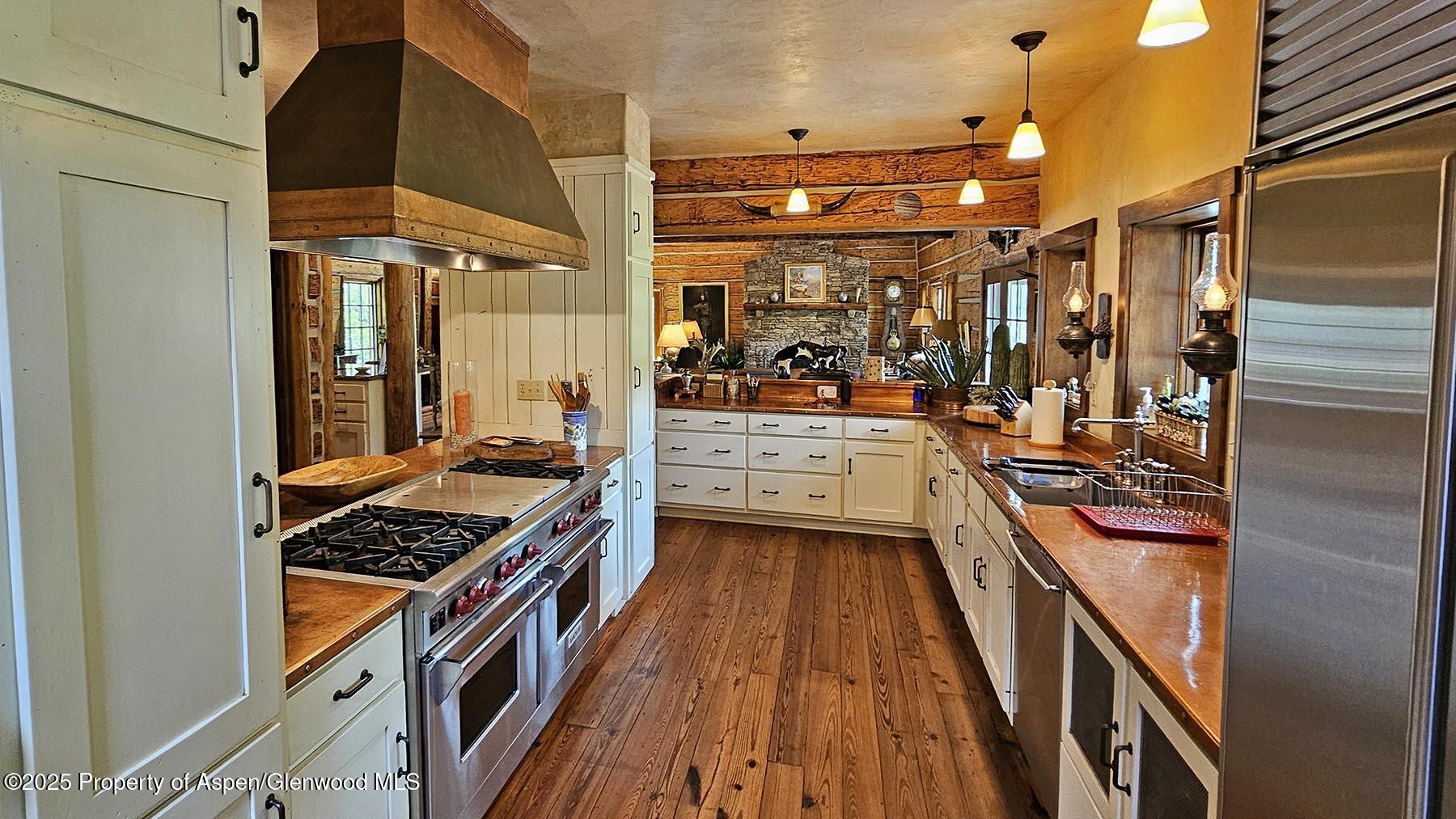 2650 Sweetwater Road Gypsum, CO 81637 - Photo 51 of 87 a kitchen with stainless steel appliances a stove and a refrigerator