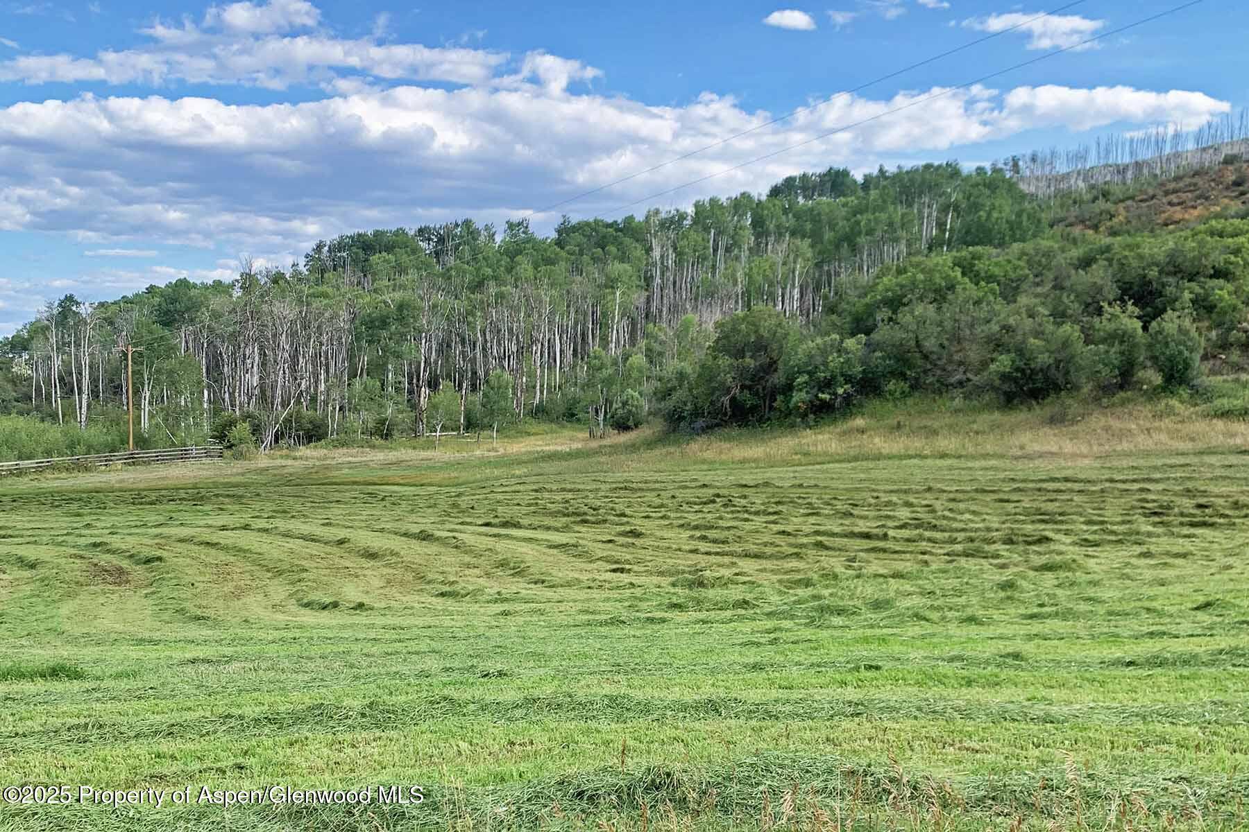 2650 Sweetwater Road Gypsum, CO 81637 - Photo 68 of 87 a view of a green field with sunset