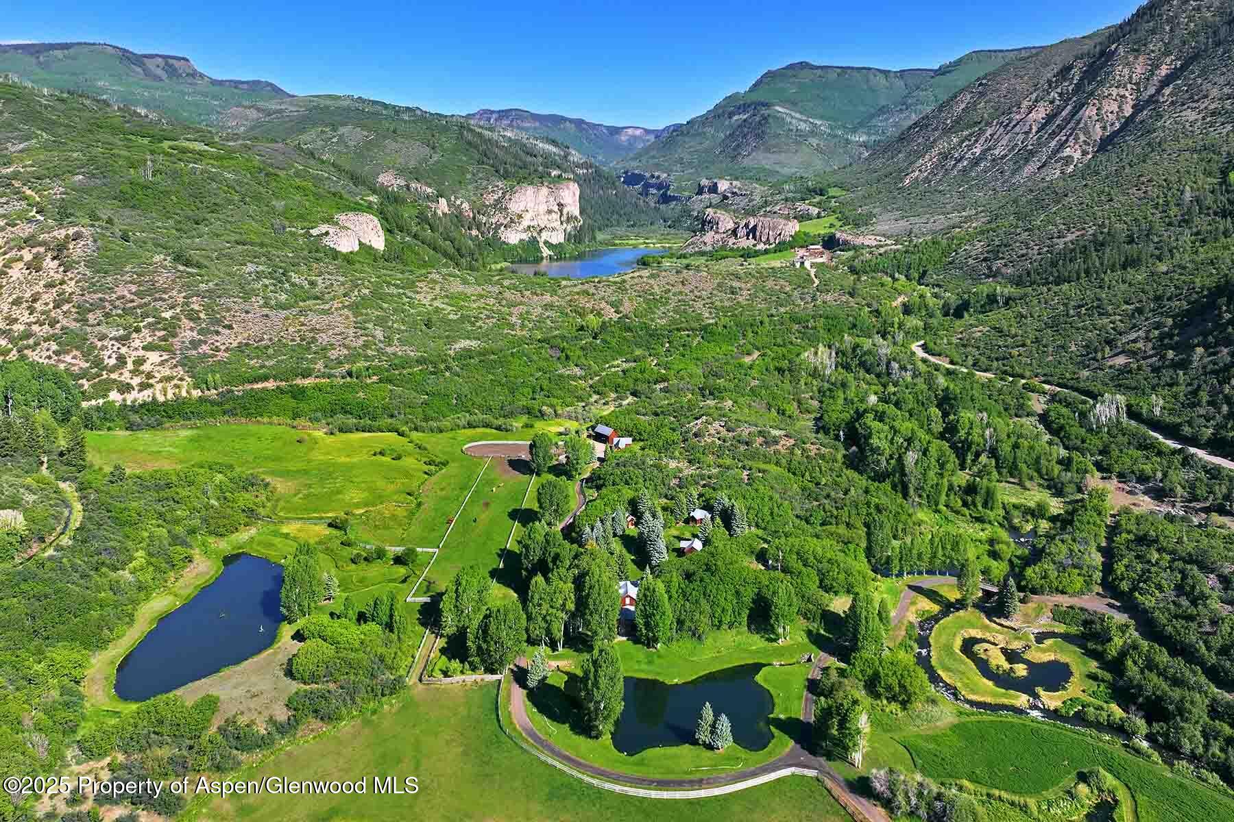 2650 Sweetwater Road Gypsum, CO 81637 - Photo 72 of 87 a view of a lush green hillside and a houses