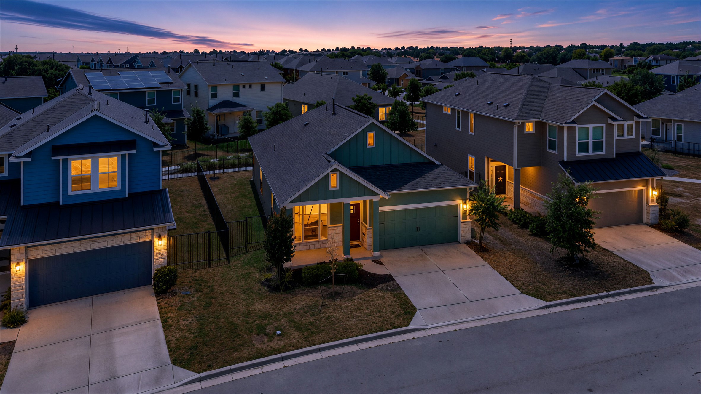 162 Rains Kyle, TX 78640 - Photo 25 of 32 Aerial view of front of home showcaseing a charming suburban streetscape lined with craftsman-inspired single-family homes.
