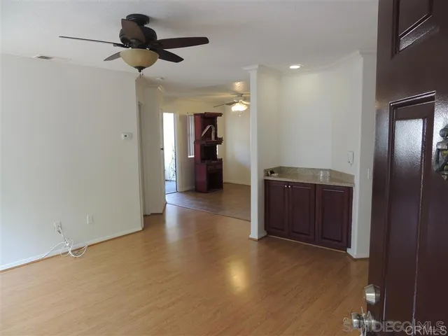 a view of hallway with a mirror and a ceiling fan