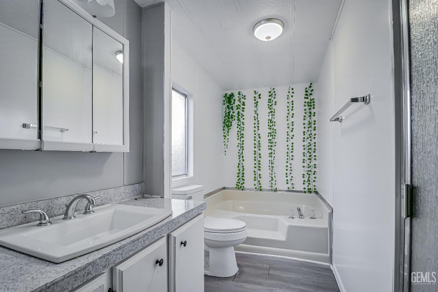 Undisclosed Address Bakersfield, CA 93312 - Photo 13 of 18 a bathroom with a granite countertop sink toilet and bathtub