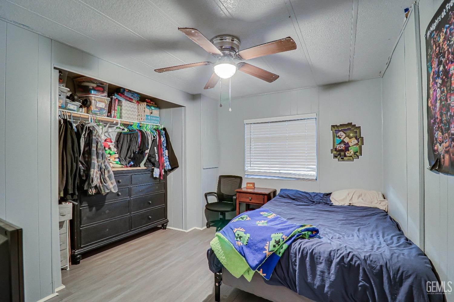 Undisclosed Address Bakersfield, CA 93312 - Photo 14 of 18 a bedroom with a bed and a walk in closet