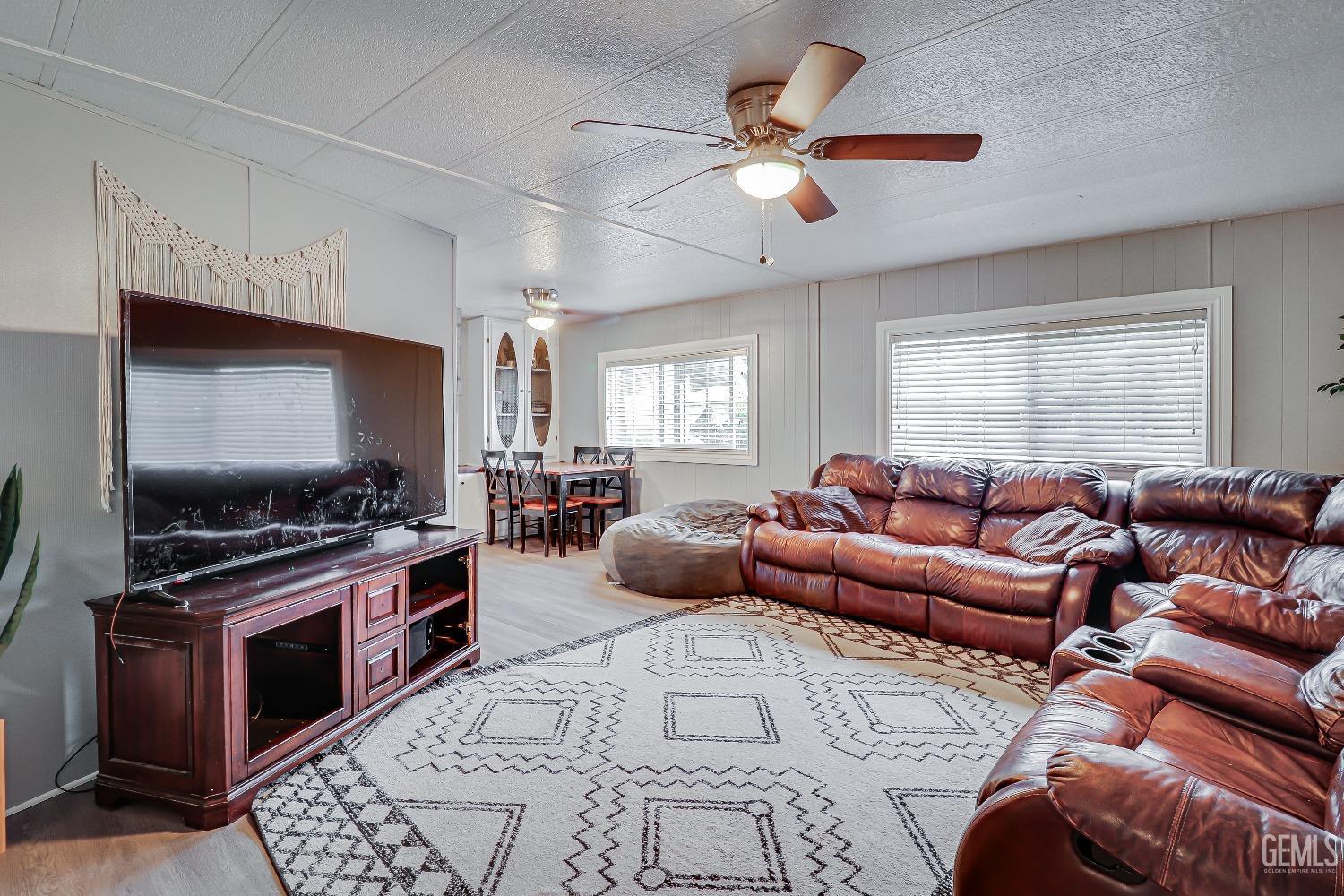 Undisclosed Address Bakersfield, CA 93312 - Photo 6 of 18 a living room with furniture and a flat screen tv