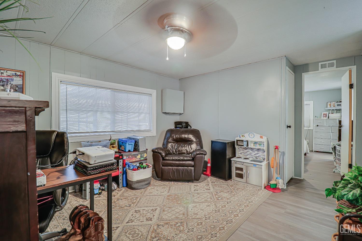 Undisclosed Address Bakersfield, CA 93312 - Photo 10 of 18 a living room with furniture a flat screen tv and a fireplace
