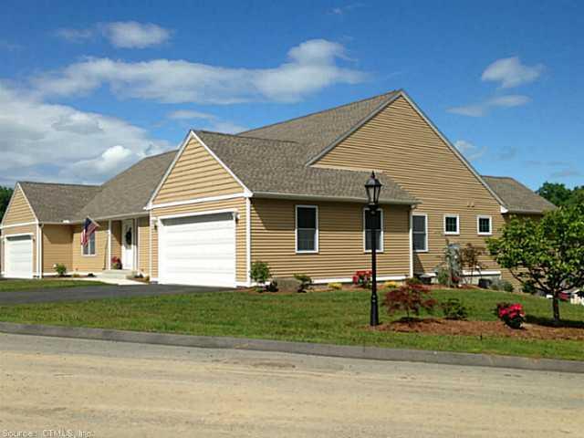 39 Providence Road, Unit 24A Brooklyn, CT 06234 - Photo 1 of 1 a front view of a house with a yard and garage
