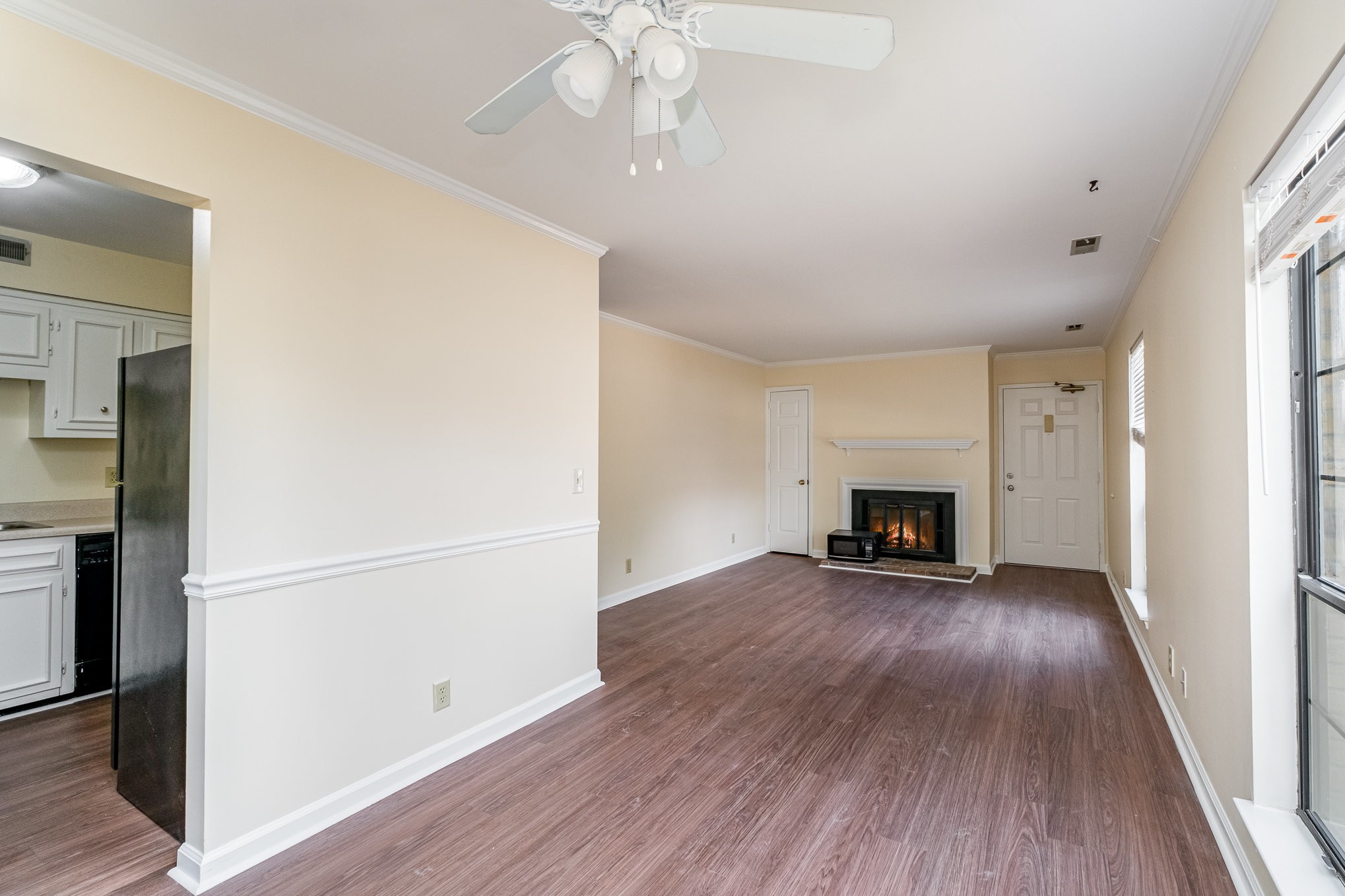 757 Fox Ridge Drive Brentwood, TN 37027 - Photo 8 of 21 an empty room with wooden floor fireplace and windows