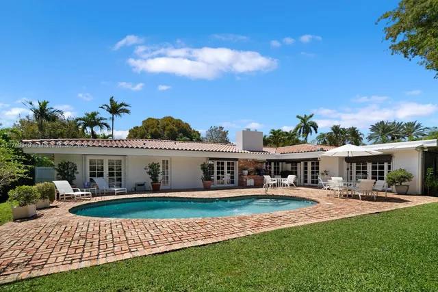 a view of a house with swimming pool and porch