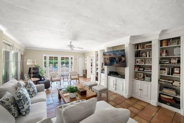 a living room with furniture and a book shelf