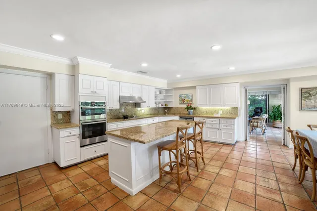 a kitchen with stainless steel appliances kitchen island granite countertop a counter top space and cabinets