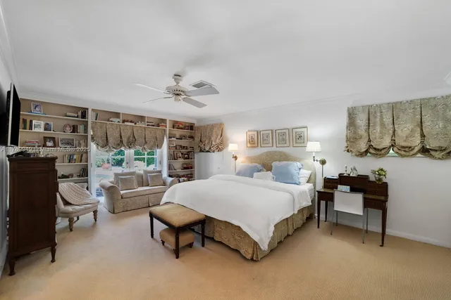 a spacious bedroom with a bed and a table