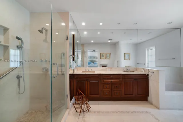 a spacious bathroom with a granite countertop sink mirror and shower