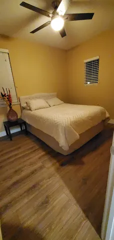 a bedroom with a bed and a night stand