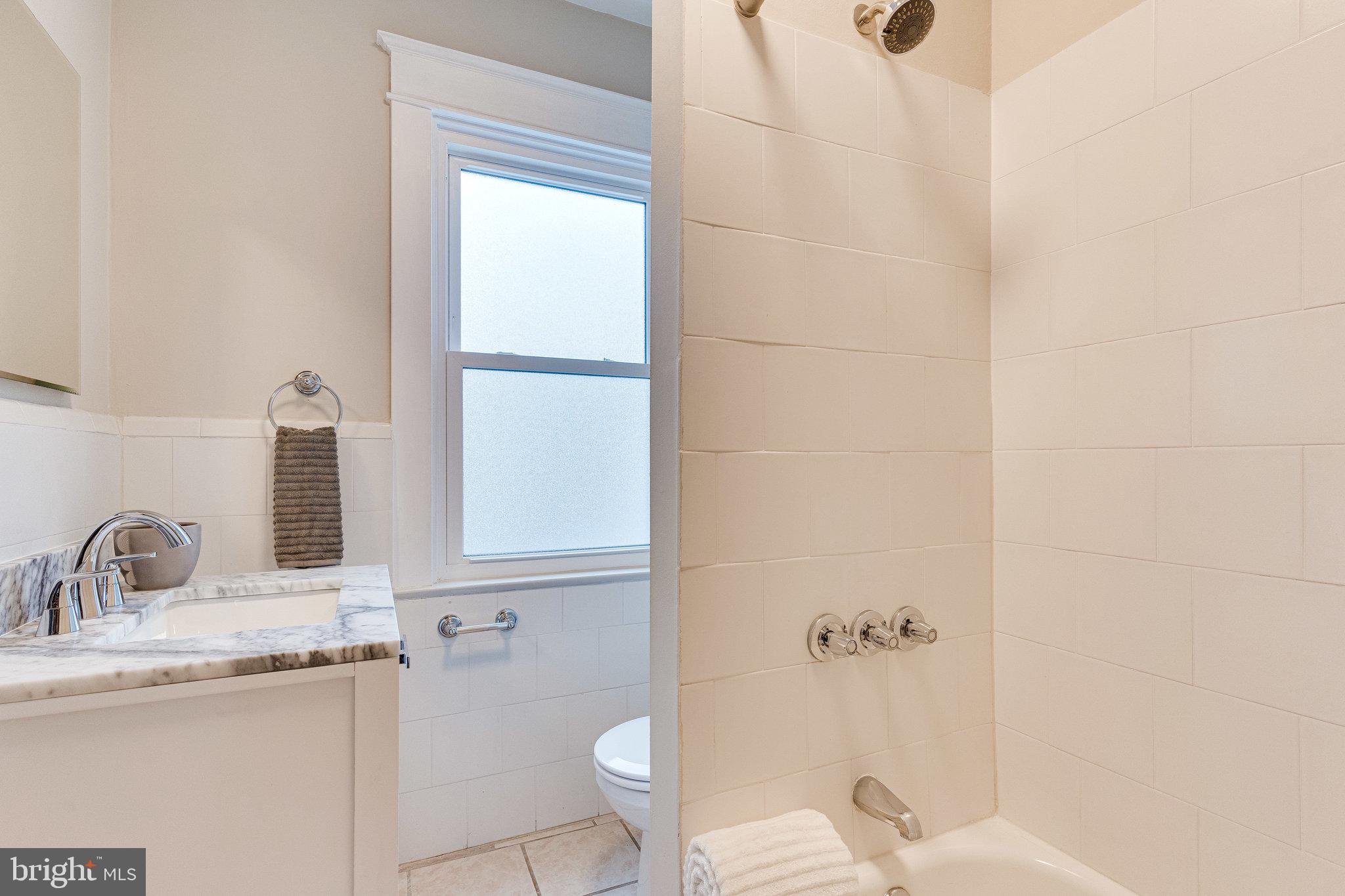 4215 7th Street Northwest Washington, DC 20011 - Photo 30 of 57 Primary bath features new marble top vanity