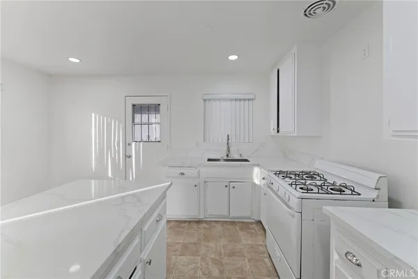 a kitchen with a stove and cabinets