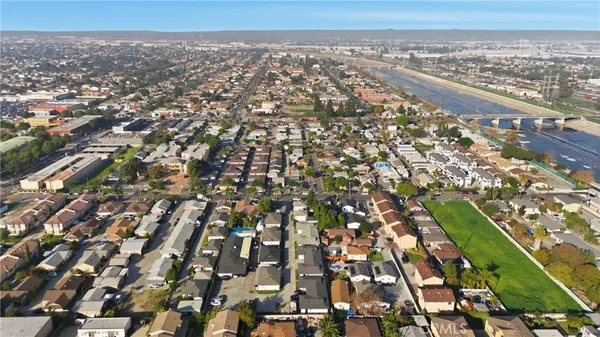 an aerial view of a residential apartment building with yard and parking