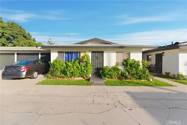 a front view of a house with a yard and a garage