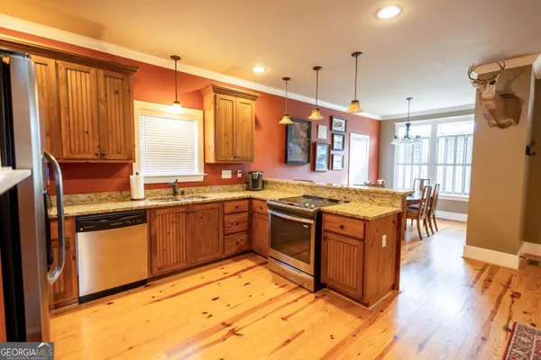 a kitchen with stainless steel appliances granite countertop a stove and a refrigerator