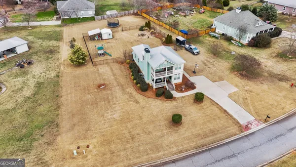 an aerial view of a house with a yard and sitting space