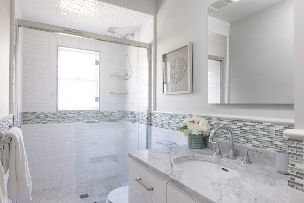 12 Balcarres Road Newton, MA 02465 - Photo 17 of 22 a bathroom with a granite countertop sink a mirror and a shower