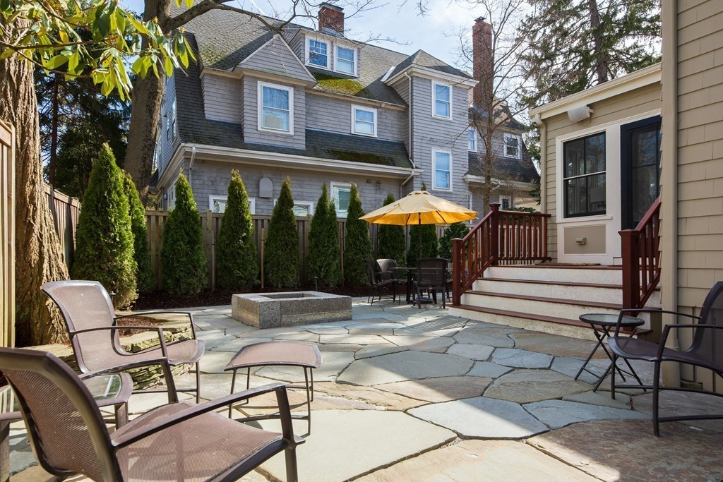 12 Balcarres Road Newton, MA 02465 - Photo 22 of 22 a patio with a table and chairs under an umbrella