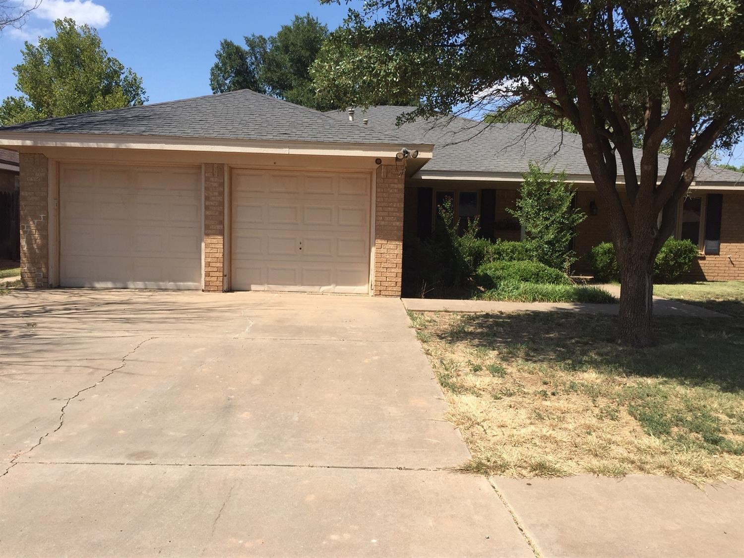 5708 91st Street Lubbock, TX 79424 - Photo 1 of 16 a front view of a house with a yard and garage