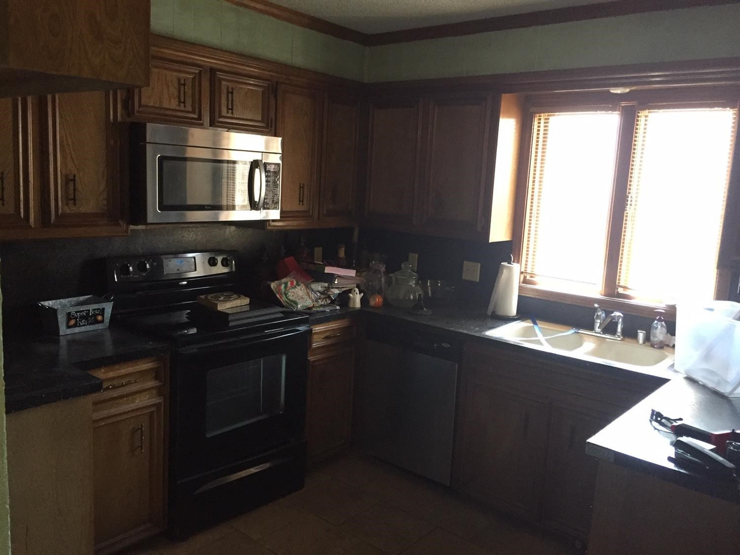 5708 91st Street Lubbock, TX 79424 - Photo 12 of 16 a kitchen with a sink stove and microwave