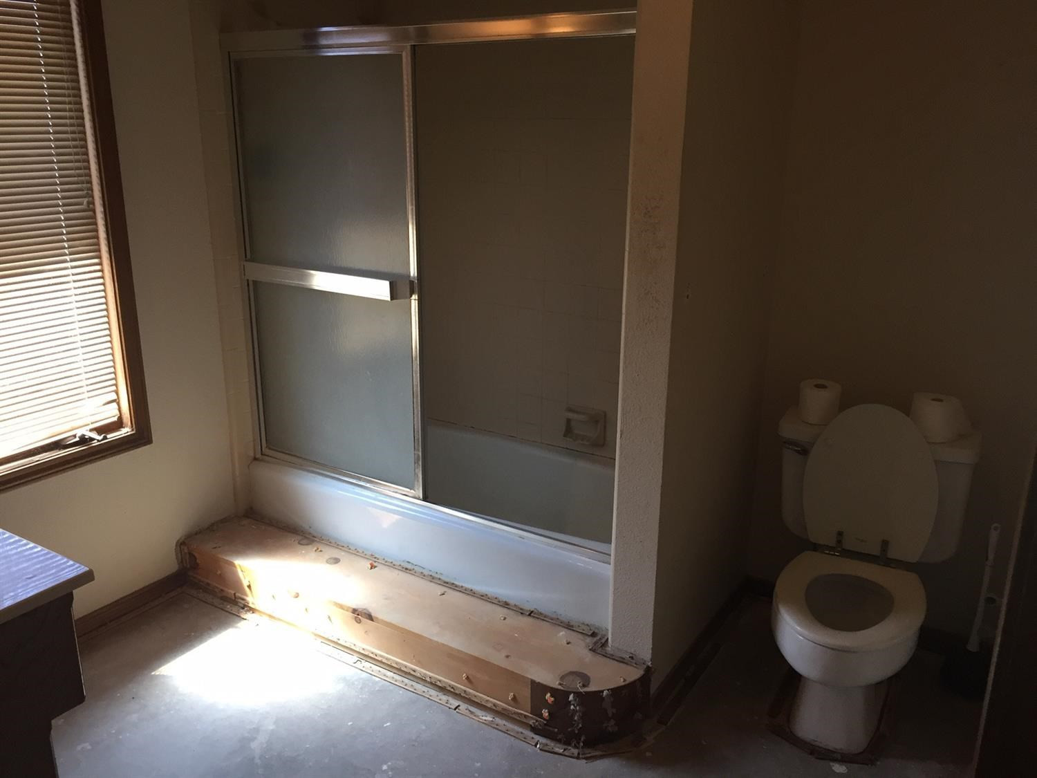 5708 91st Street Lubbock, TX 79424 - Photo 15 of 16 a bathroom with a toilet and a shower
