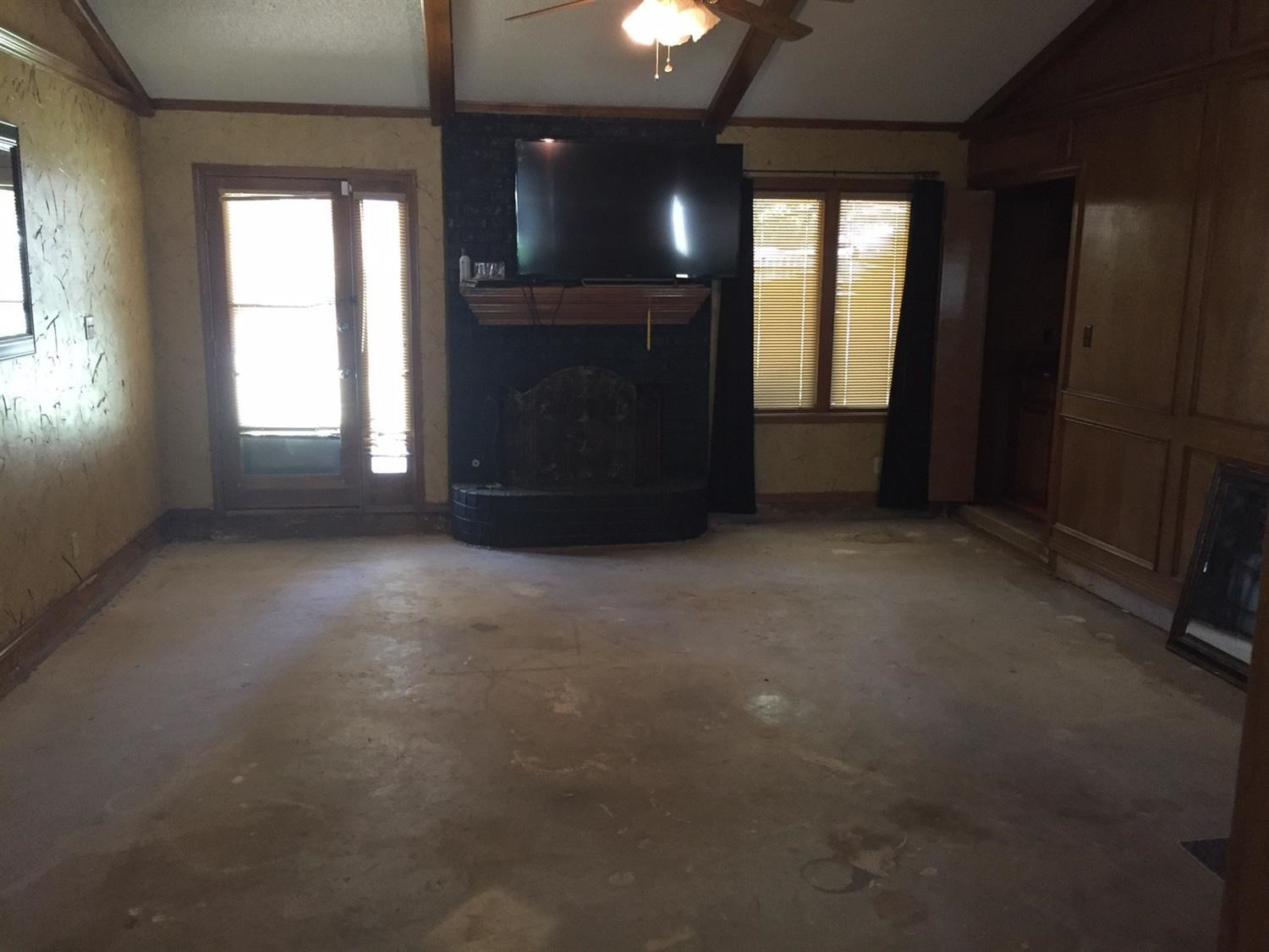 5708 91st Street Lubbock, TX 79424 - Photo 6 of 16 an empty room with windows and fireplace
