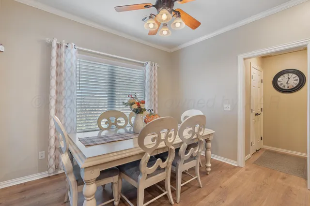 a dining room with furniture and wooden floor