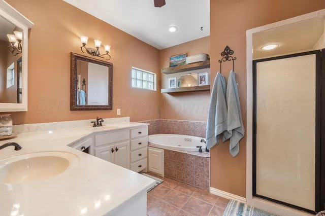 a bath tub sitting next to a white sink and a shower